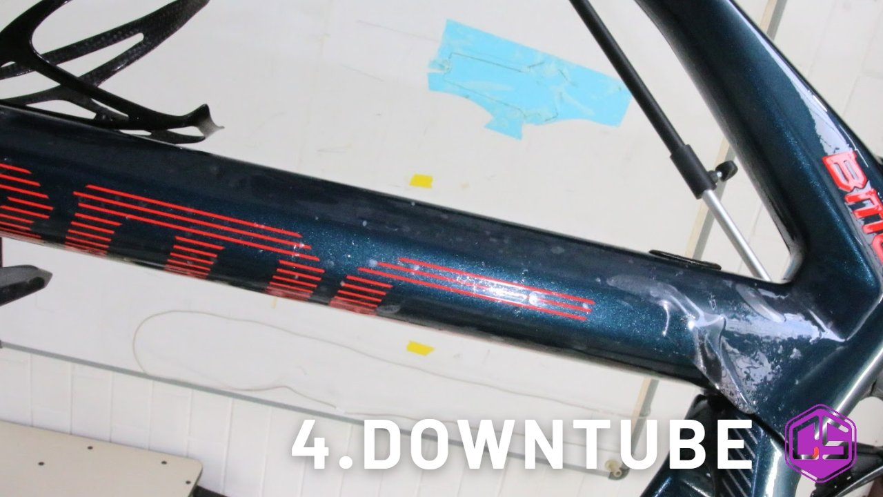 Glossy downtube with red accents, showcasing impressive frame protection angle.